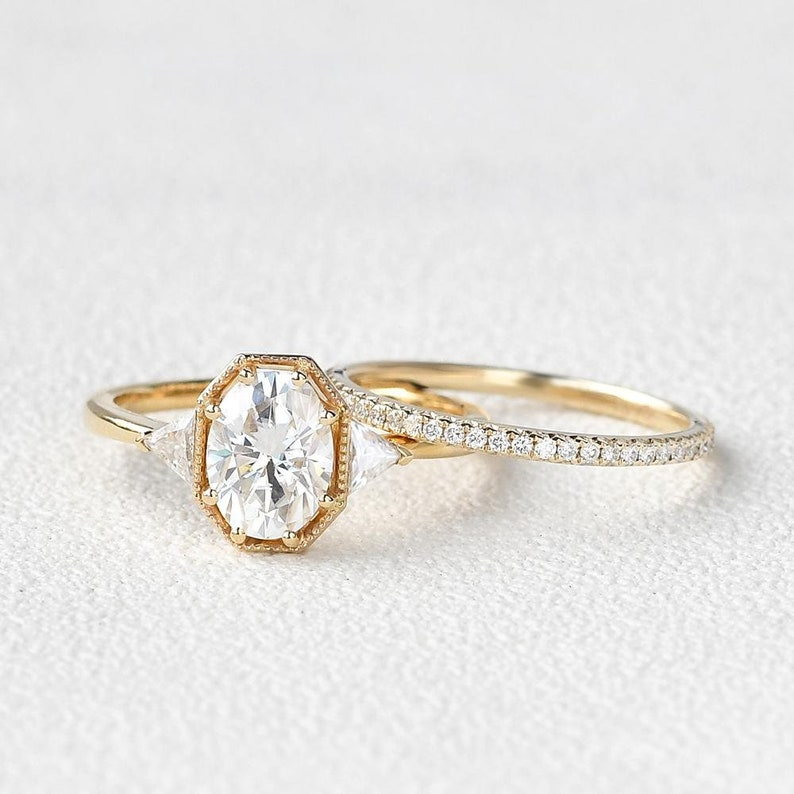 Vintage Oval Diamond Ring | Gold Trilogy Engagement Ring Vintage oval diamond engagement ring with gold trilogy setting and side stones.