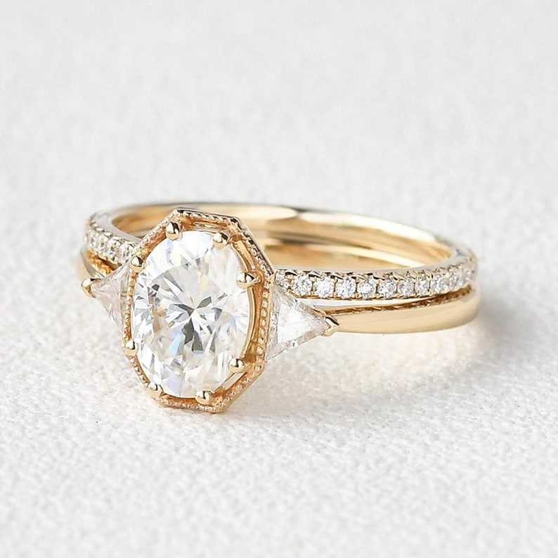 Vintage Oval Diamond Ring | Gold Trilogy Engagement Ring Vintage oval diamond engagement ring with gold trilogy setting and side stones.